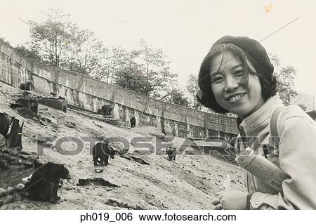 Stock Photograph - Asian woman at the zoo. Fotosearch
