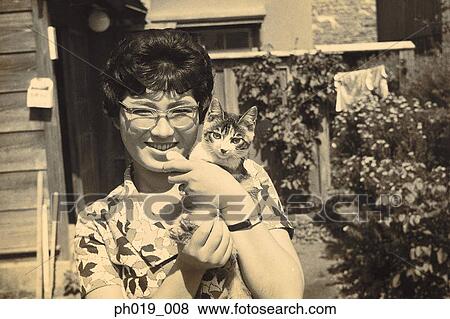 Asian woman carrying a cat View Large Photo Image Stock Photo - Asian woman carrying a cat. Fotosearch