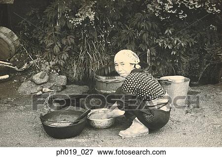 Asian woman cleaning utensils View Large Photo Image Stock Photo - Asian woman cleaning utensils. Fotosearch
