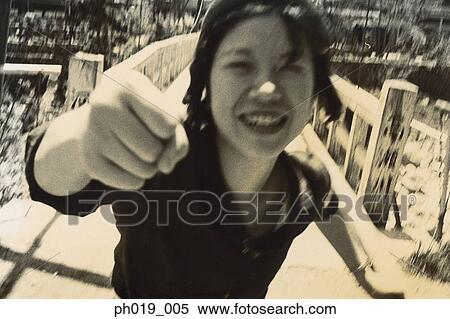 Stock Photography - Asian woman clenching her fist. Fotosearch