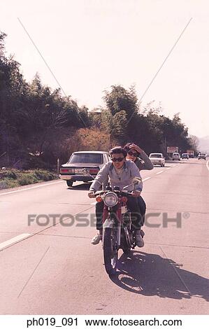 Couple riding on motorcycle View Large Photo Image Stock Image - Couple riding on motorcycle. Fotosearch