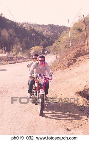 Couple riding on motorcycle View Large Photo Image Stock Image - Couple riding on motorcycle. Fotosearch