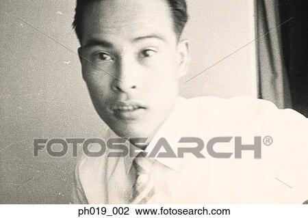 Stock Image - Portrait of an Asian man in business attire. Fotosearch