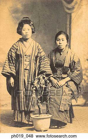 Portrait of two Asian women in traditional Japanese costume View Large Photo Image Stock Photo - Portrait of two Asian women in traditional Japanese costume. Fotosearch