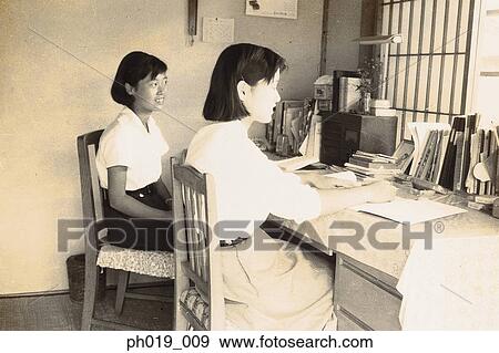 Two Asian women at the study table View Large Photo Image Stock Photo - Two Asian women at the study table. Fotosearch
