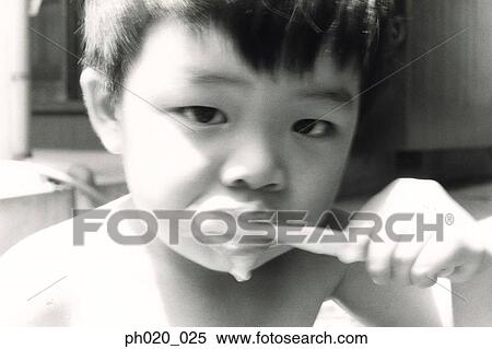 Stock Photography - Boy brushing teeth. Fotosearch