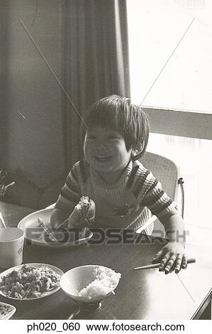 Boy eating lunch at home View Large Photo Image Stock Image - Boy eating lunch at home. Fotosearch
