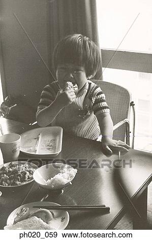 Boy eating lunch at home View Large Photo Image Stock Photo - Boy eating lunch at home. Fotosearch