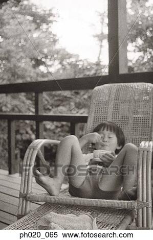Boy eating snack at balcony View Large Photo Image Stock Photography - Boy eating snack at balcony. Fotosearch