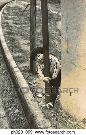 Stock Photo - Boy hugging street lamp. Fotosearch