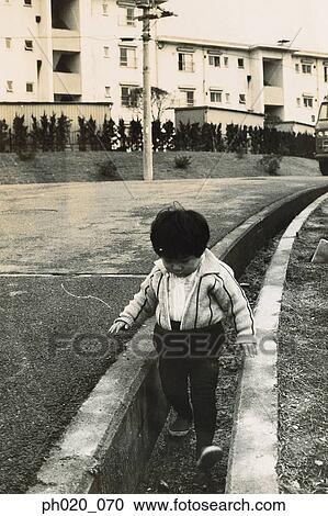 Boy playing in drainage View Large Photo Image Stock Image - Boy playing in drainage. Fotosearch