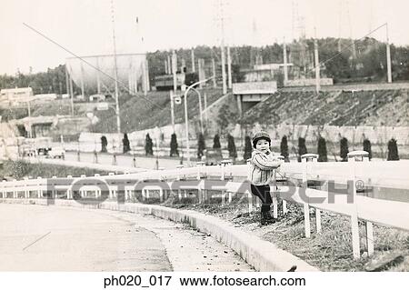 Girl standing by the bent of the road View Large Photo Image Stock Photo - Girl standing by the bent of the road. Fotosearch