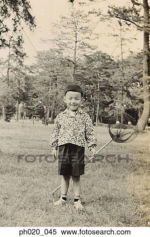 Stock Photography - Portrait of a boy at garden. Fotosearch