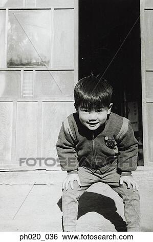Stock Photograph - Portrait of a boy at the door. Fotosearch