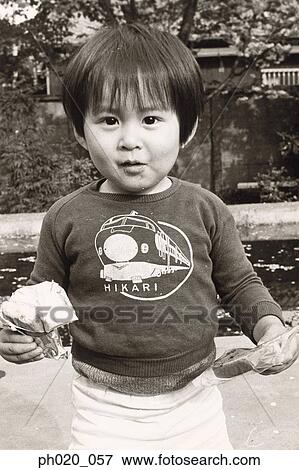 Portrait of a boy holding snacks View Large Photo Image Stock Photo - Portrait of a boy holding snacks. Fotosearch