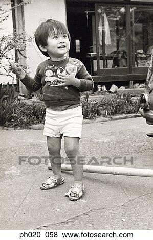 Portrait of a boy holding snacks View Large Photo Image Stock Photo - Portrait of a boy holding snacks. Fotosearch