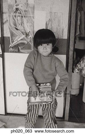 Portrait of a boy leaning against door View Large Photo Image Stock Image - Portrait of a boy leaning against door. Fotosearch