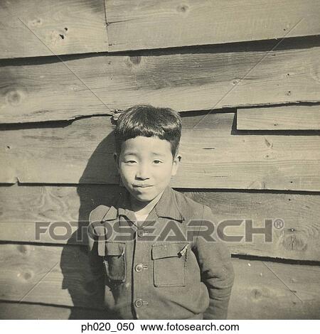 Portrait of a boy leaning against wooden wall View Large Photo Image Stock Image - Portrait of a boy leaning against wooden wall. Fotosearch