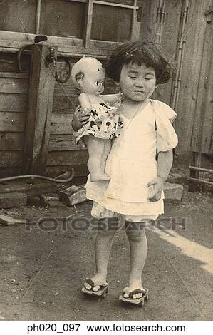 Portrait of a girl and plastic doll View Large Photo Image Stock Photo - Portrait of a girl and plastic doll. Fotosearch