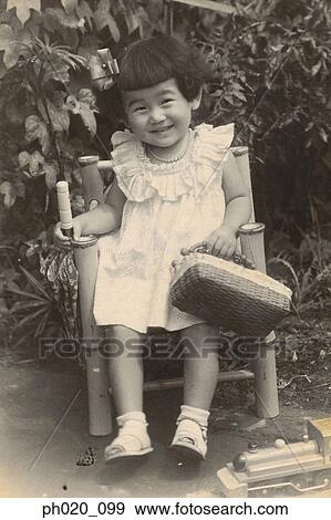 Portrait of a girl sitting at the garden View Large Photo Image Stock Photo - Portrait of a girl sitting at the garden. Fotosearch