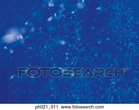 Stock Image - Bubbles rising through water, underwater view. Fotosearch