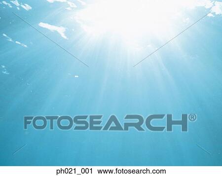 Sunlight fanning out from ocean surface View Large Photo Image Stock Image - Sunlight fanning out from ocean surface . Fotosearch