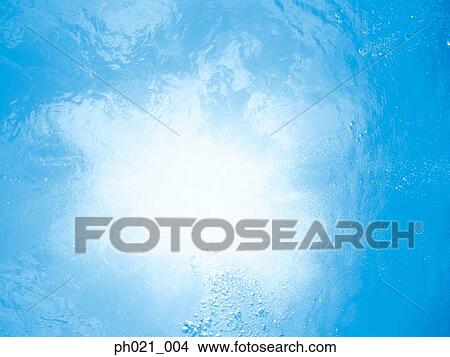 Sunlight filtering through water surface View Large Photo Image Picture - Sunlight filtering through water surface . Fotosearch