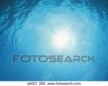 Sunlight filtering through water surface View Large Photo Image Stock Photography - Sunlight filtering through water surface . Fotosearch