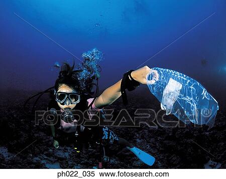 Female scuba diver holding plastic bottle View Large Photo Image Stock Photography - Female scuba diver holding plastic bottle. Fotosearch