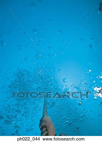 Human hand holding rope, underwater view View Large Photo Image Picture - Human hand holding rope, underwater view. Fotosearch