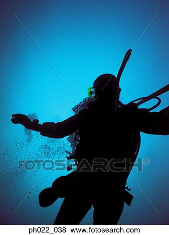 Stock Photo - Scuba diver rising to surface, silhouette. Fotosearch