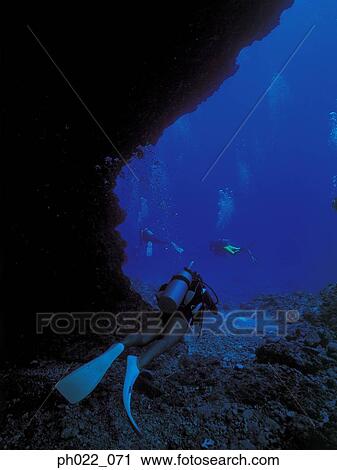Scuba divers in cave exit View Large Photo Image Stock Image - Scuba divers in cave exit. Fotosearch