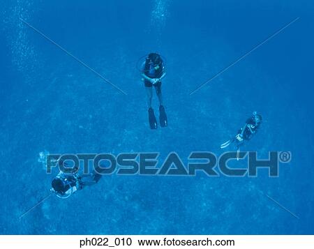 Three scuba divers underwater, underwater view View Large Photo Image Stock Image - Three scuba divers underwater, underwater view. Fotosearch