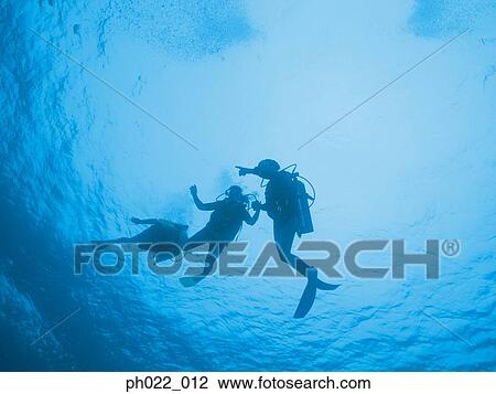 Three scuba divers underwater, silhouette View Large Photo Image Stock Image - Three scuba divers underwater, silhouette. Fotosearch