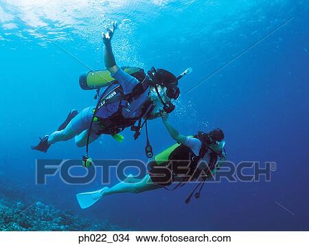 Two scuba divers underwater View Large Photo Image Picture - Two scuba divers underwater. Fotosearch