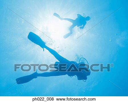 Two scuba divers underwater, silhouette View Large Photo Image Stock Photo - Two scuba divers underwater, silhouette. Fotosearch