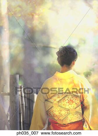 Stock Photo - Back view of Japanese woman in traditional costume. Fotosearch