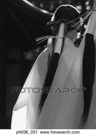 Stock Image - Back view of women in Japanese traditional costume. Fotosearch
