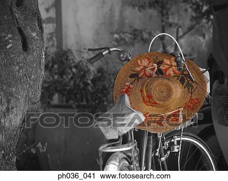Stock Image - Straw hat and a bicycle. Fotosearch