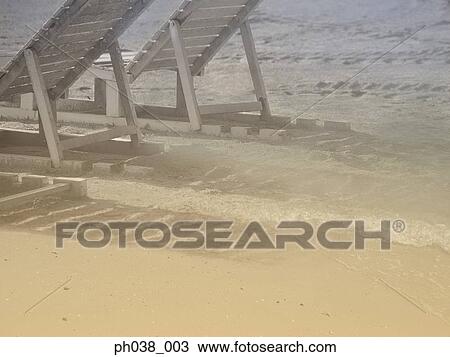 Stock Image -  Adirondack Chair on beach. Fotosearch