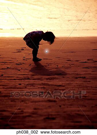 Girl in bending position and a glowing light View Large Photo Image Stock Image - Girl in bending position and a glowing light. Fotosearch