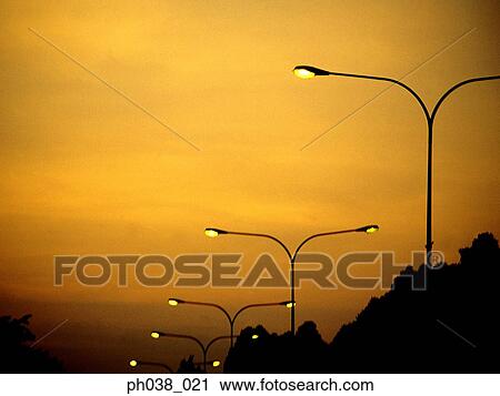Row of street lamps at sunset View Large Photo Image Stock Image - Row of street lamps at sunset. Fotosearch