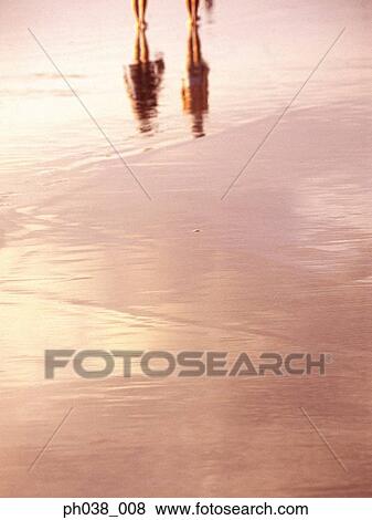 Stock Photo - Water reflection of two persons. Fotosearch