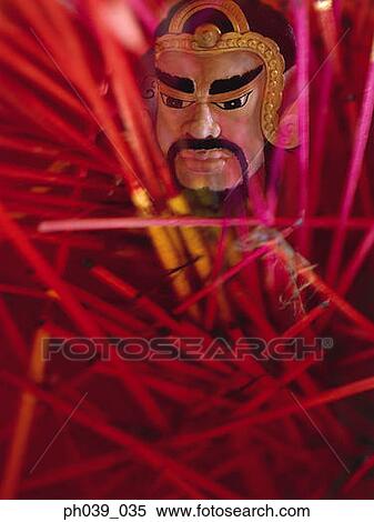 Joss sticks and the face of the Chinese God View Large Photo Image Stock Photography - Joss sticks and the face of the Chinese God. Fotosearch