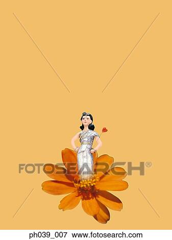 Painting of a woman standing on flower head View Large Photo Image Stock Photo - Painting of a woman standing on flower head. Fotosearch