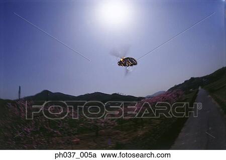 Stock Image - Bumblebee in flight, view directly below. Fotosearch