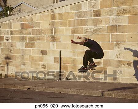 Skateboarder in mid-air View Large Photo Image Stock Image - Skateboarder in mid-air . Fotosearch