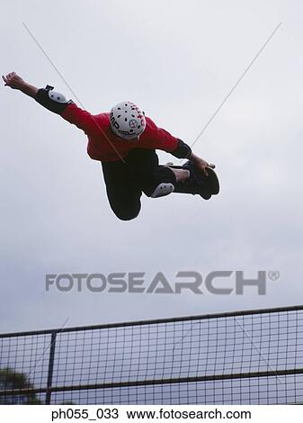 Stock Image - Skateboarder in mid air. Fotosearch