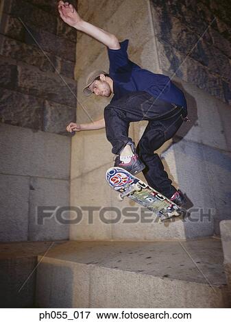 Skateboarder in mid-air View Large Photo Image Stock Photo - Skateboarder in mid-air . Fotosearch