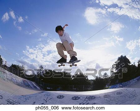 Stock Photograph - Skateboarder in mid air. Fotosearch